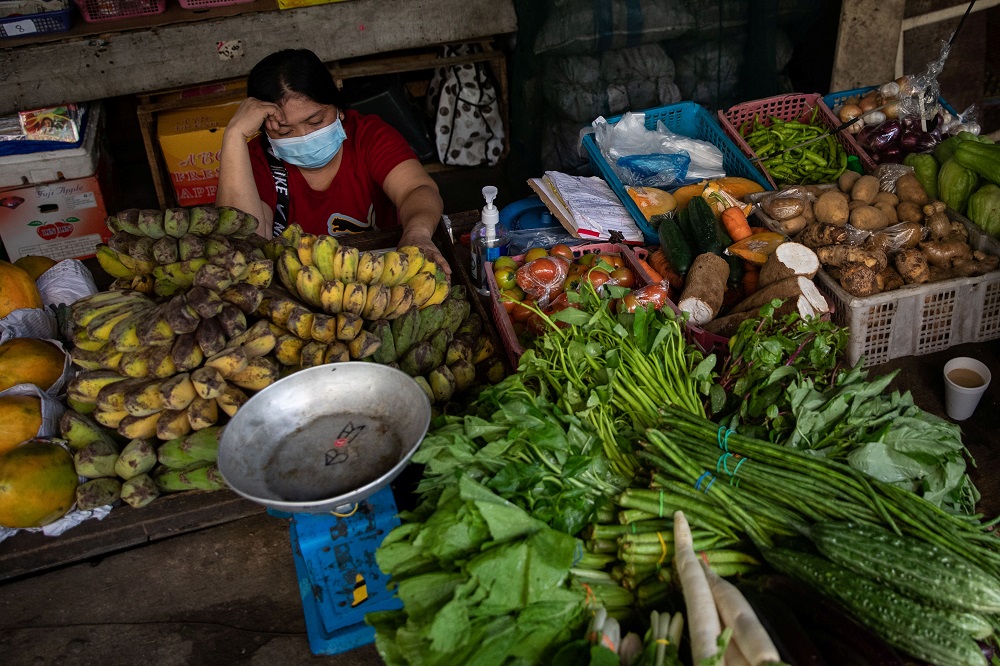 A vendor wearing a face mask for protection against the coronavirus disease rests in her fruit and vegetable stall in a public market in Quezon City, Metro Manila January 5, 2021. u00e2u20acu201d Reuters pic