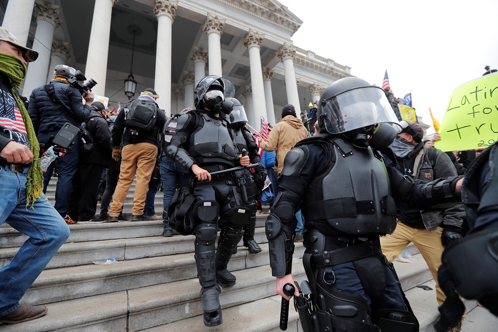 Law enforcement officers walk down the steps of US Capitol during a protest against the certification of the 2020 US presidential election results by the US Congress, in Washington January 6, 2021. u00e2u20acu201d Reuters pic