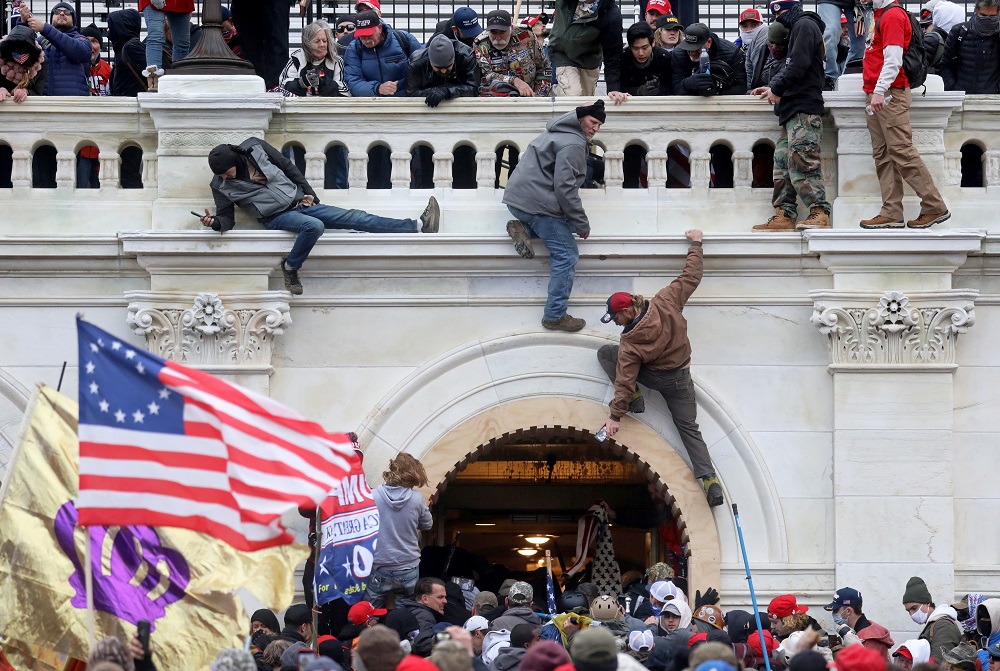 A mob of supporters of US President Donald Trump fight with members of law enforcement at a door they broke open as they storm the US Capitol Building in Washington January 6, 2021. u00e2u20acu201d Reuters pic