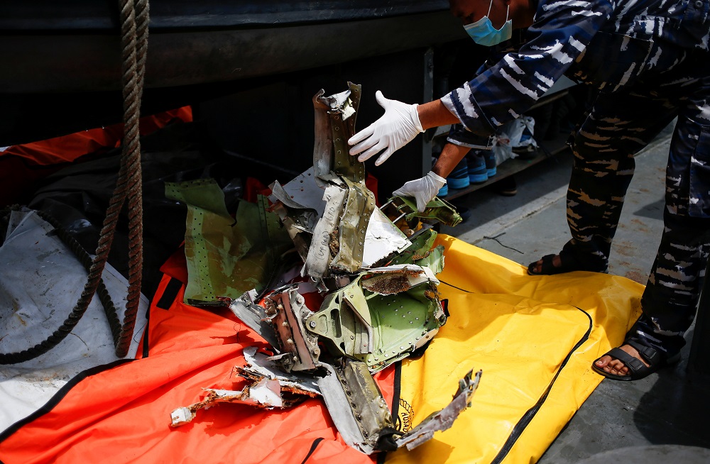 A member of the Indonesian navy inspects a piece of debris of Sriwijaya Air flight SJ182, which crashed to the sea, at the Jakarta coast January 12, 2021. u00e2u20acu201d Reuters pic