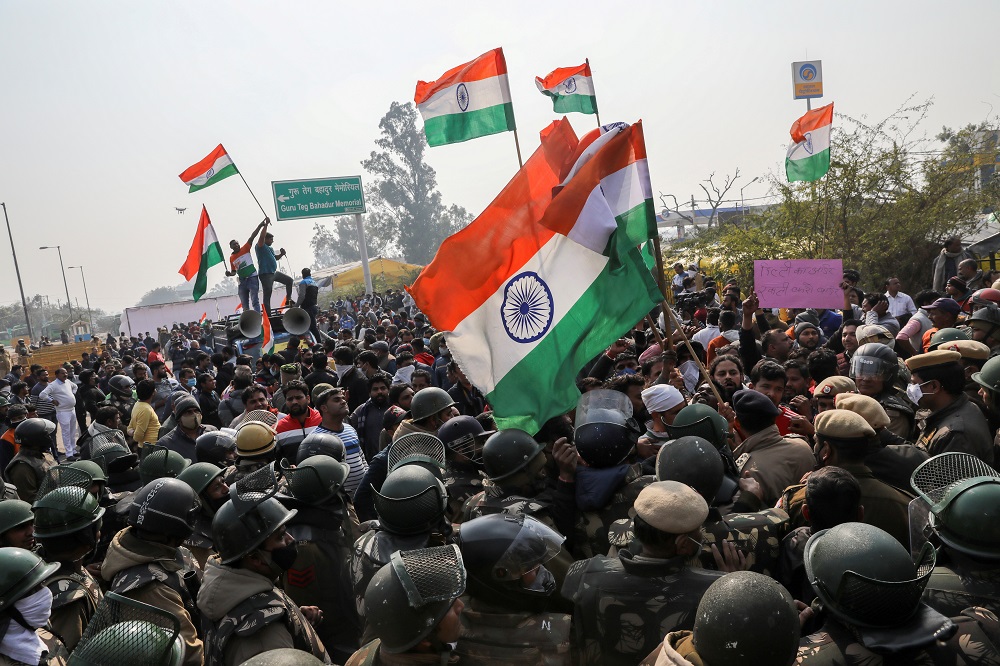 People shout anti-farmers slogans and wave Indiau00e2u20acu2122s flags as police officers try to stop them, at a site of the protest against farm laws at Singhu border near New Delhi January 29, 2021. u00e2u20acu201d Reuters pic