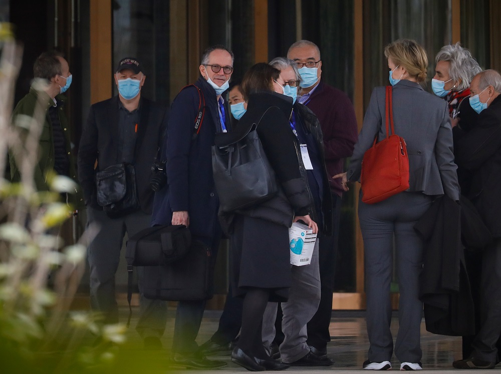 Members of the World Health Organisation team tasked with investigating the origins of the coronavirus pandemic, talk outside their hotel after returning from their second field trip in Wuhan, Hubei province January 30, 2021. u00e2u20acu201d Reuters pic
