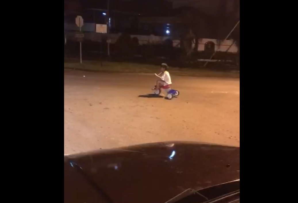 A little boy cycling alone in the middle of the night in a quiet neighbourhood spooks the villagers. u00e2u20acu201d Screen capture via Facebook/myKKSabah
