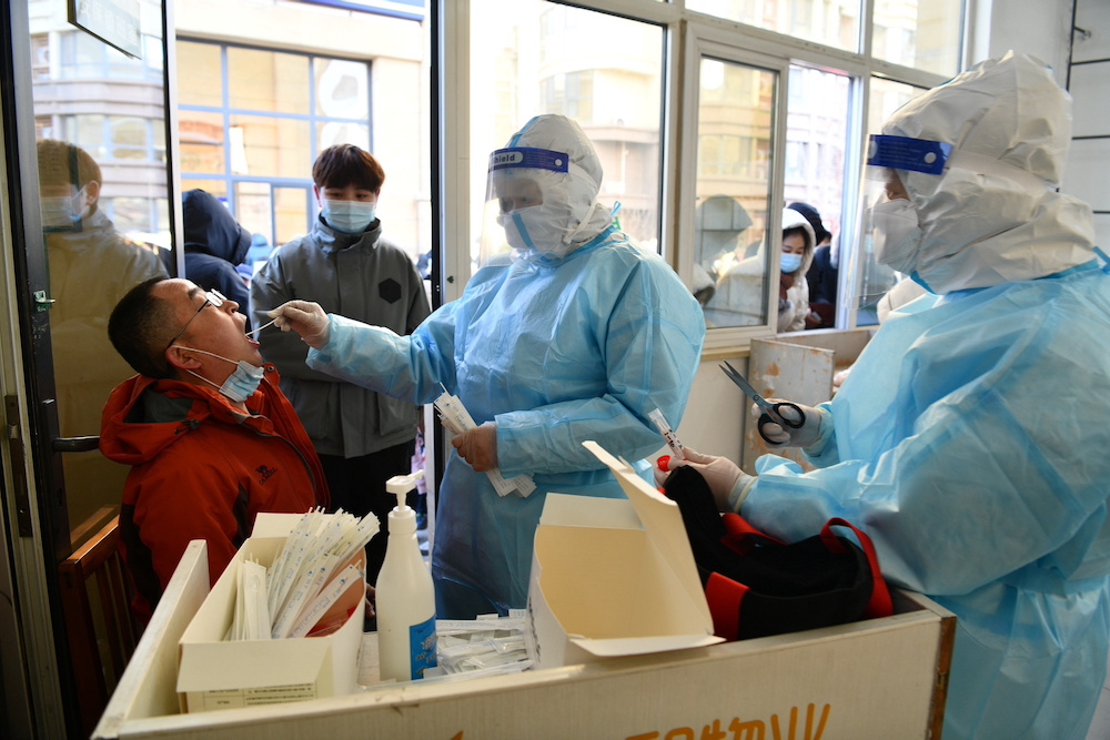 A medical worker in a protective suit collects a swab sample from a resident during a mass nucleic acid testing following a recent coronavirus disease (Covid-19) outbreak in Shijiazhuang, Hebei province, China January 6, 2021.u00e2u20acu201d Reuters pic