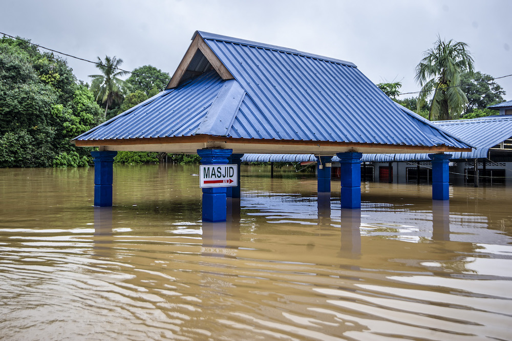 A hut is seen partially submerged in floodwaters following a heavy monsoon downpour in Temerloh, Pahang on January 9, 2021 u00e2u20acu201dPicture by Shafwan Zaidonn