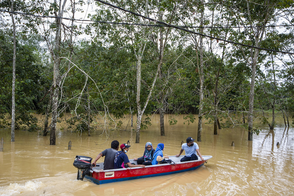 Lebak Seberang villagers ride a boat through floodwaters following a heavy monsoon downpour in Temerloh, Pahang on January 9, 2021 u00e2u20acu201d Picture by Shafwan Zaidonn
