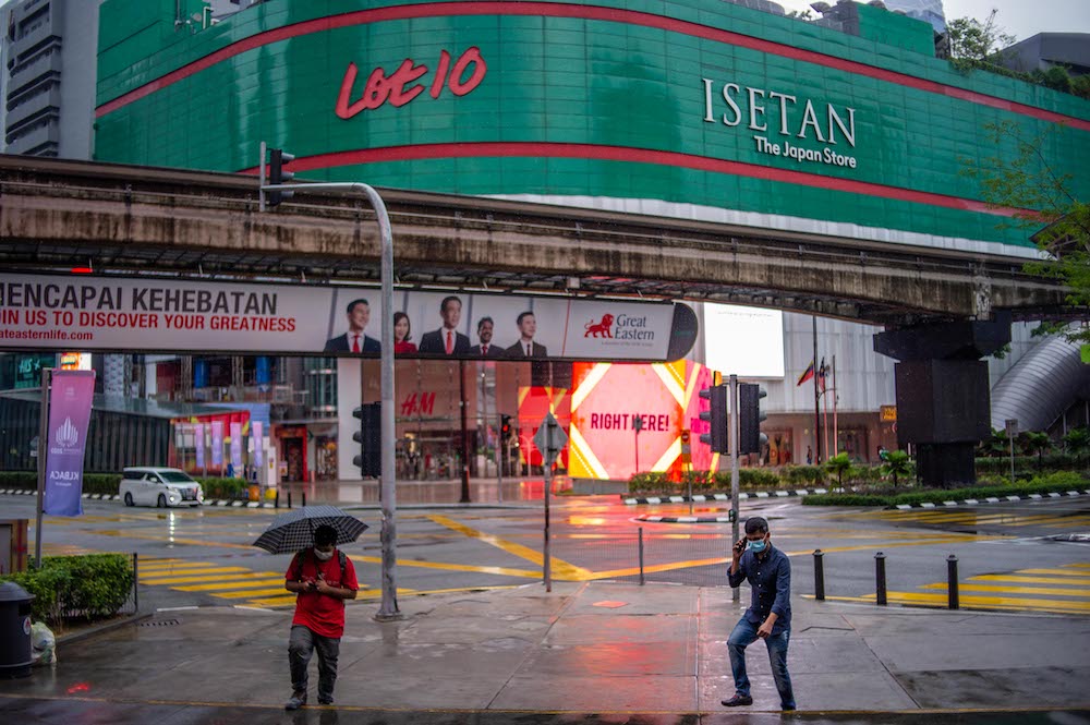 A man walking with an umbrella in the deserted city of Kuala Lumpur on January 17, 2021. u00e2u20acu201d Picture by Shafwan Zaidon