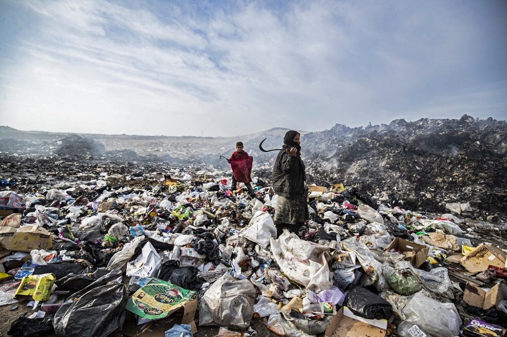 Syrians sift through a garbage dump near an oil field in the countryside of Malikiya in northeast Syria January 12, 2021. u00e2u20acu201d AFP pic