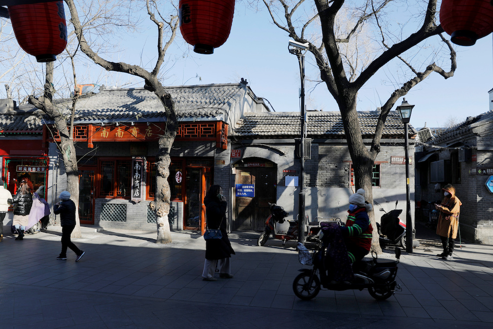 People wearing protective masks walk along Nanluoguxiang alley, following the coronavirus disease (Covid-19) outbreak, in Beijing, China January 16, 2021. u00e2u20acu201d Reuters pic