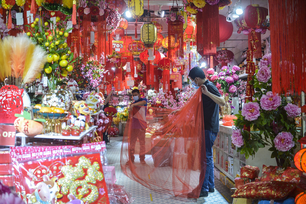 Shop workers are busy arranging Chinese New Year items in Kuala Lumpur on January 21, 2020. — Picture by Miera Zulyana
