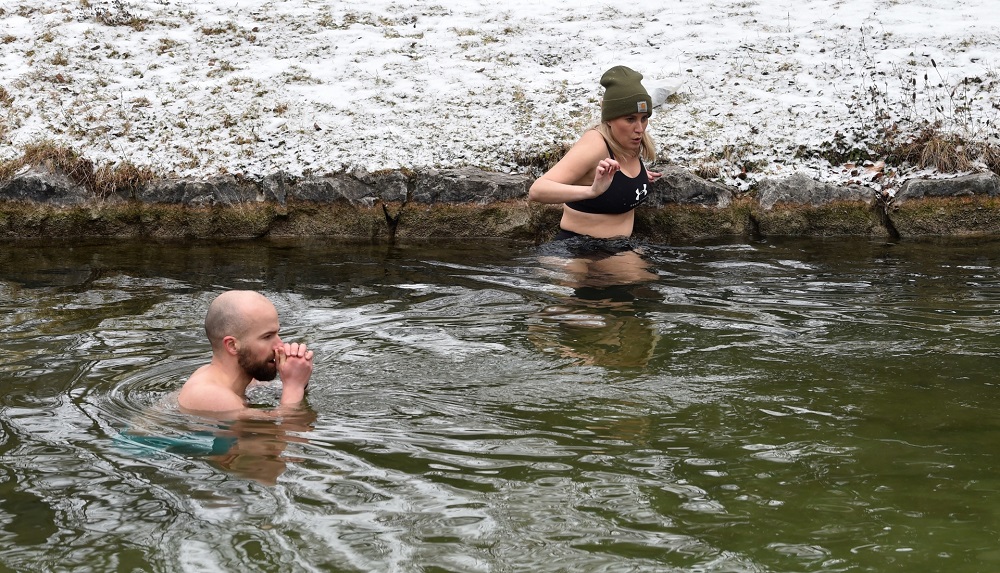 Ice swimmers Irina Hey and Franz Mayr go into the water of the canal of the Eisbach river at the English Garden park in Munich. u00e2u20acu201d AFP pic