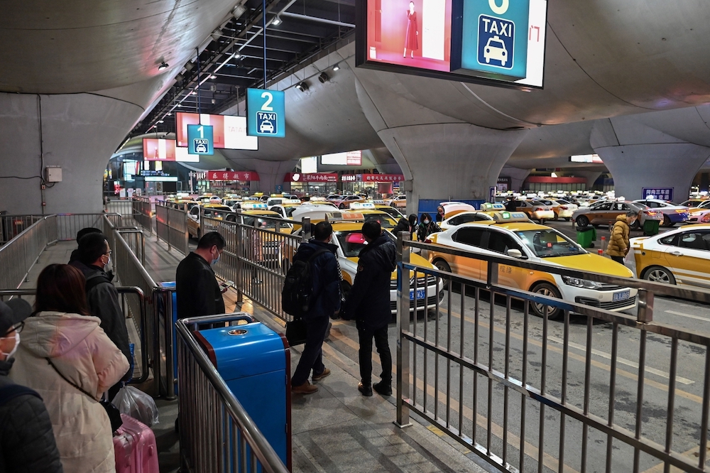 Passengers waiting for taxis outside Wuhan train station in Wuhan in China's central Hubei province. u00e2u20acu201d AFP pic
