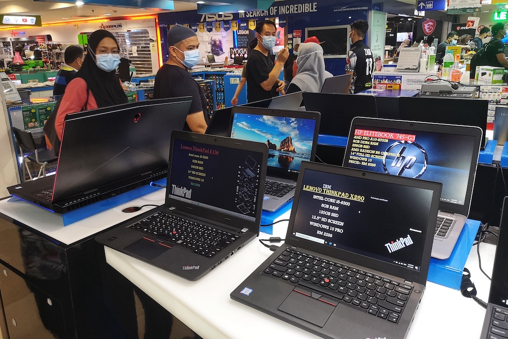 People looking at laptops and computers at Digital Mall in Petaling Jaya January 24, 2021. u00e2u20acu201d Picture by Shafwan Zaidon