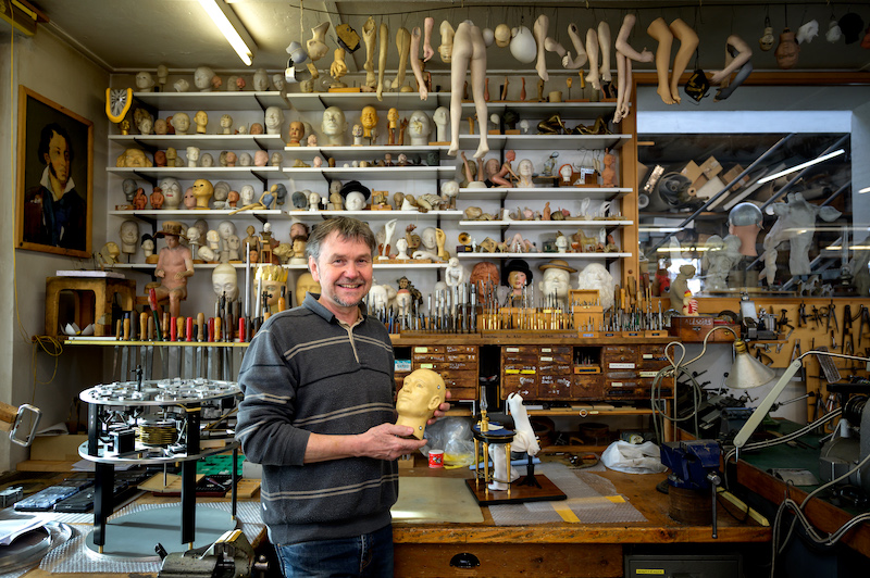 A picture taken on January 19, 2021 shows Swiss master Francois Junod posing with his tools and some heads used for the molding of parts of moving mechanical artworks, in his workshop in Sainte-Croix. — AFP pic