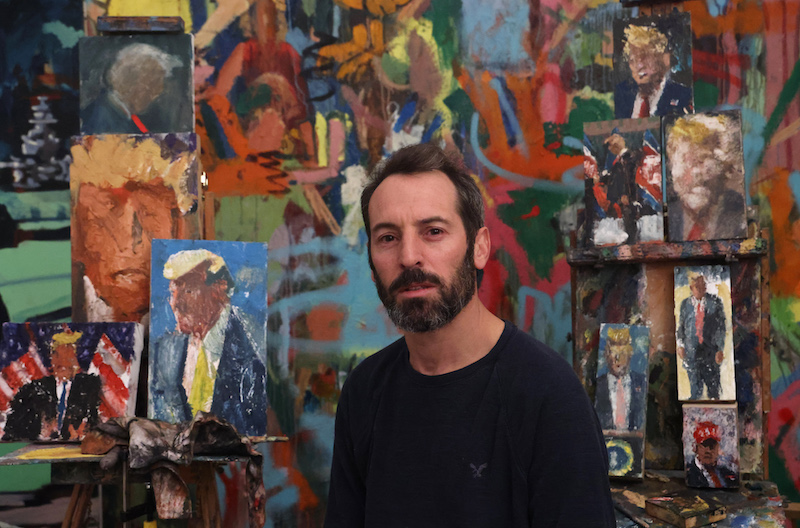 Israeli painter Iddo Markus poses for a picture at his studio, surrounded by his paintings of former US president Donald Trump, in the northern port city of Haifa January 22, 2021. u00e2u20acu201d AFP pic