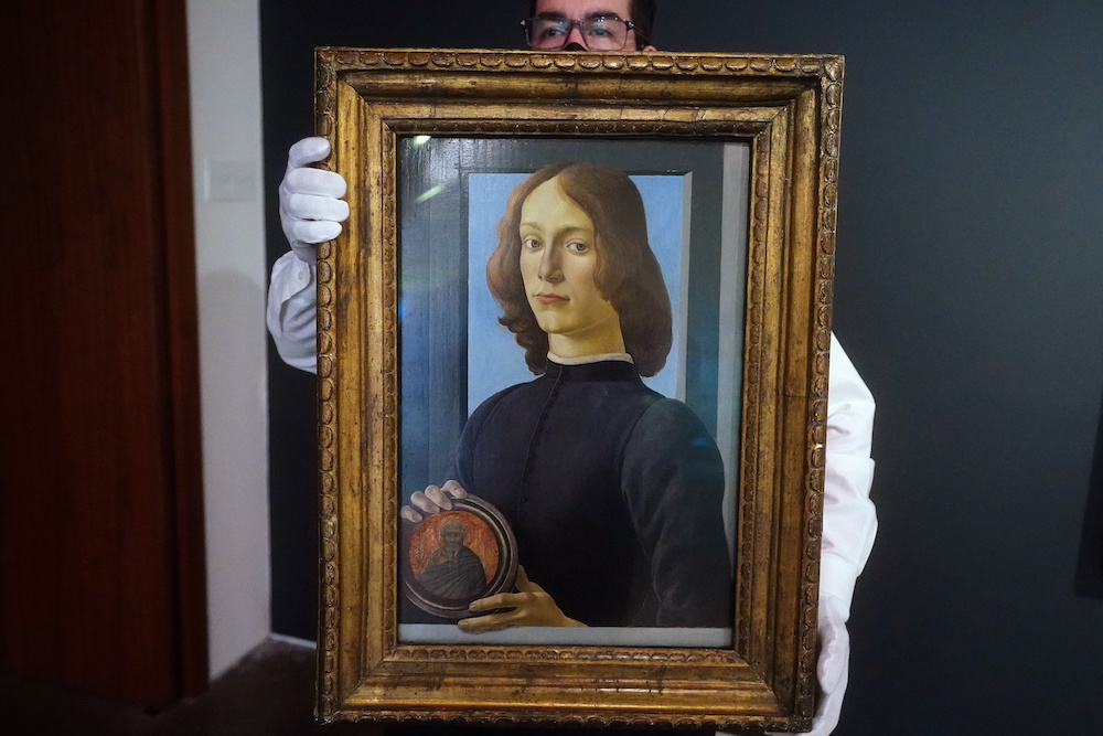A worker at Sotheby's Auctions poses with Sandro Botticelli's u00e2u20acu02dcYoung Man Holding a Roundelu00e2u20acu2122 during a preview where it is expected to fetch in excess of US$80 million in Manhattan January 22, 2021. u00e2u20acu201d Reuters pic