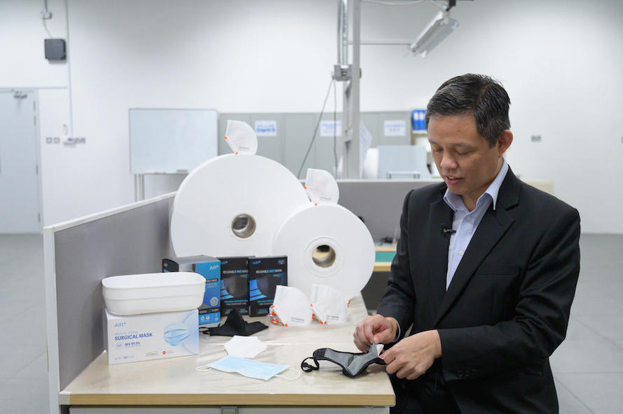 Trade and Industry Minister Chan Chun Sing inserting the filter produced by ST Engineering into a reusable face mask at the firmu00e2u20acu2122s Tuas facility on Januaryuary 28, 2021. u00e2u20acu201d MTI pic via TODAY