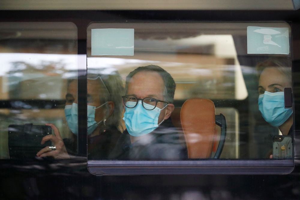 Members of the World Health Organisation (WHO) team tasked with investigating the origins of the Covid-19 pandemic sit on a bus as they leave their quarantine hotel in Wuhan January 28, 2021. u00e2u20acu201d Reuters pic