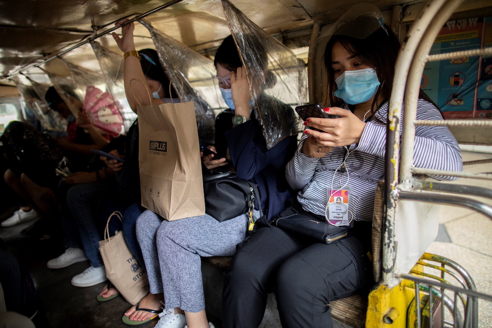 Passengers wearing masks and face shields for protection against the coronavirus disease (Covid-19) sit between plastic barriers inside a jeepney in Makati City, Metro Manila, Philippines January 27, 2021. u00e2u20acu201d Reuters pic