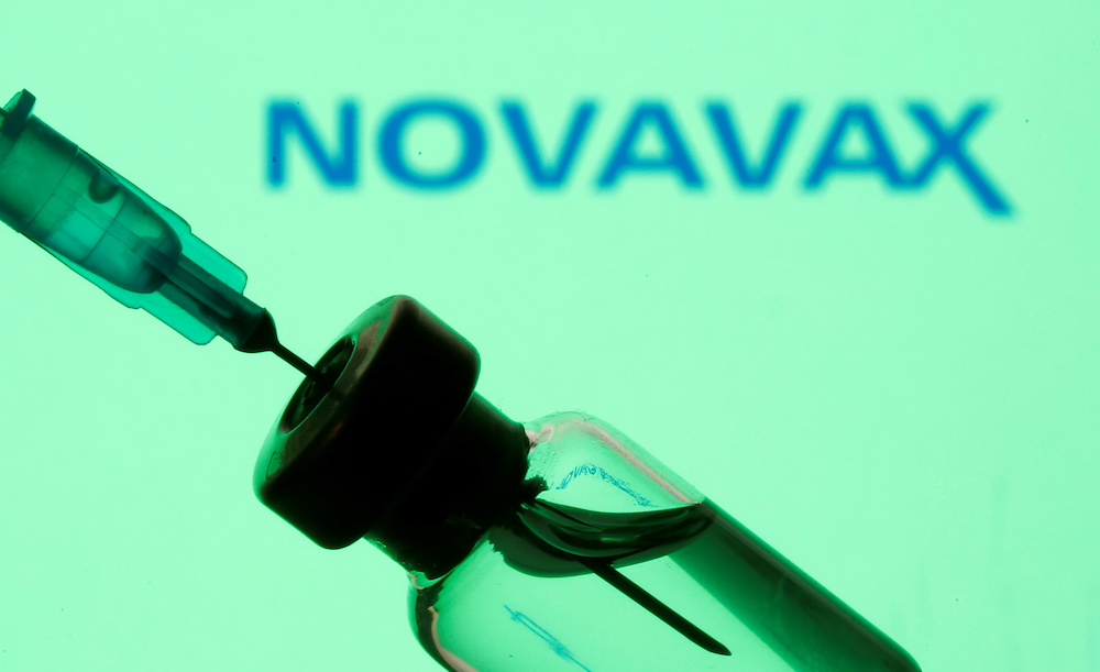 A vial and syringe are seen in front of a displayed Novavax logo in this illustration taken January 11, 2021. u00e2u20acu201d Reuters pic