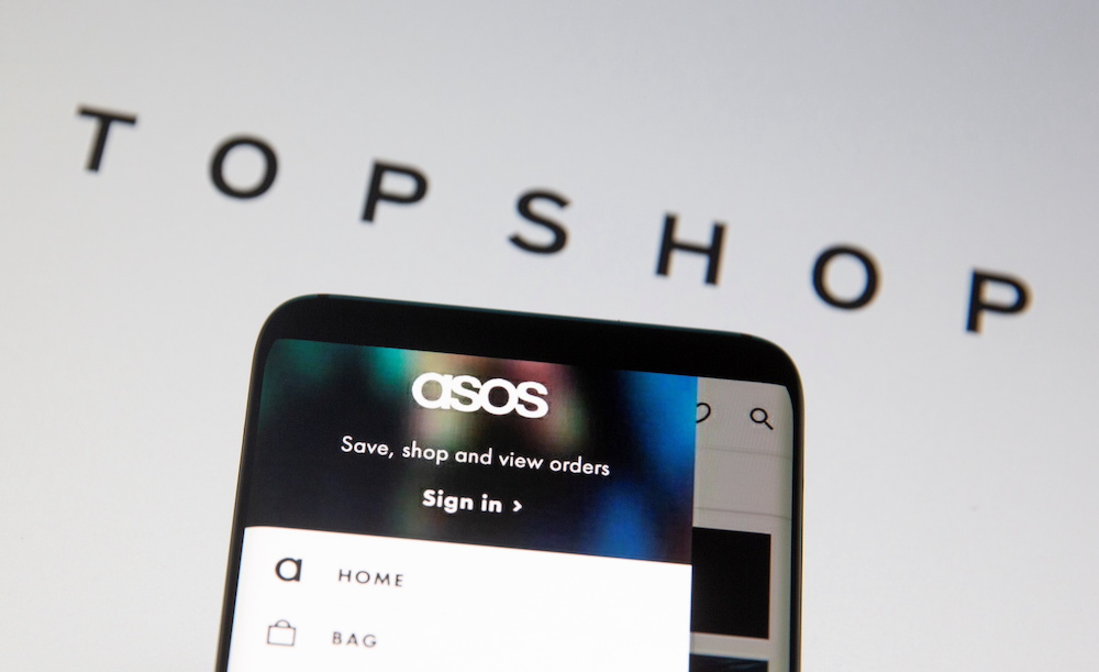 Asos logo is seen in a smartphone in front of a displayed TopShop logo in this illustration taken January 25, 2021. u00e2u20acu201d Reuters pic