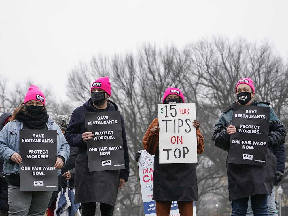 Service industry workers hold up signs during a rally in support of today's introduction of the Raise the Wage Act, which includes a US$15 minimum wage for tipped workers in Washington. u00e2u20acu201d Jemal Countess/Getty Images for One Fair Wage/AFP pic