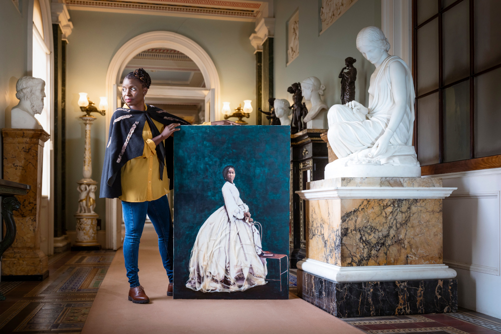 British-Zambian artist Hannah Uzor poses next to her portrait of Sarah Forbes Bonetta at Osbourne House in the Isle of Wight, Britain. u00e2u20acu201d Picture courtesy of English Heritage via Reutersnn