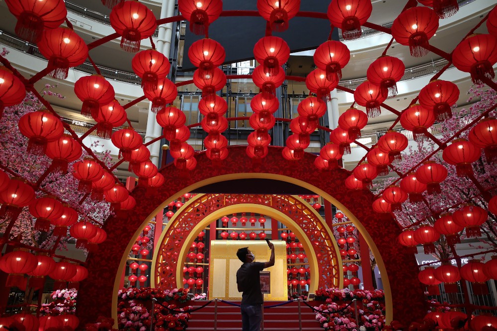 A man takes a picture of the Chinese New Year decorations ahead of the Lunar New Year celebrations at Suria KLCC mall in Kuala Lumpur January 21, 2021. u00e2u20acu201d Picture by Yusof Mat Isa