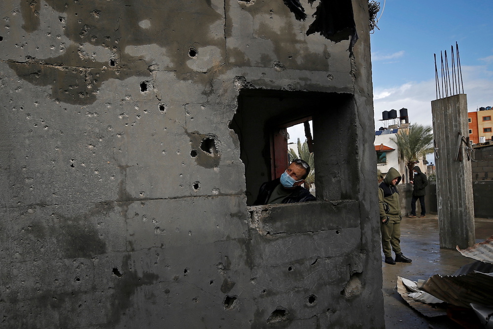 A Palestinian man inspects a damaged house near the border fence with Israel, in central Gaza Strip January 20, 2021. u00e2u20acu201d Reuters picnnnn