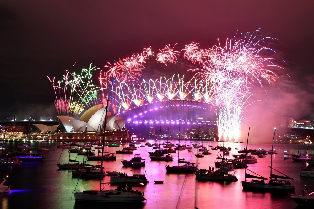 Fireworks explode over the Sydney Opera House and Sydney Harbour Bridge during downsized New Year's Eve celebrations during the Covid-19 pandemic, January 1, 2021. u00e2u20acu2022 Handout via Reuters