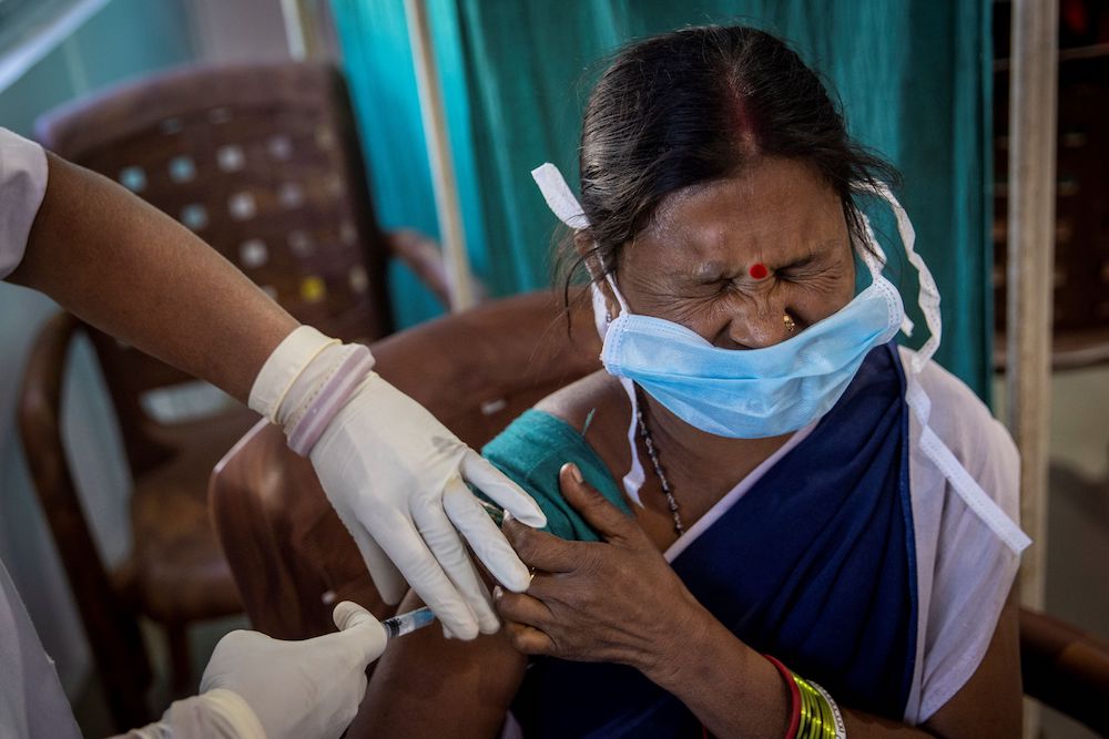 A healthcare worker reacts as she receives a dose of COVISHIELD, a Covid-19 vaccine manufactured by Serum Institute of India, during one of the world's largest Covid-19 vaccination campaigns in Odisha, India, January 16, 2021. — Reuters pic