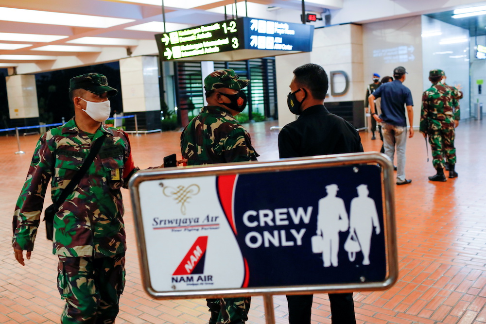Indonesian soldiers are seen at Soekarno-Hatta International Airport after Sriwijaya Air plane flight SJ182 with more than 50 people on board lost contact after taking off, according to local media, in Tangerang, near Jakarta, Indonesia, January 9, 2021. 