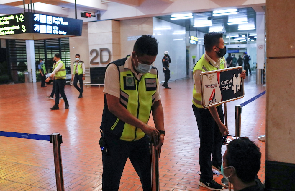 Airport officials install barriers at Soekarno-Hatta International Airport after Sriwijaya Air plane flight SJ182 with more than 50 people on board lost contact after taking off, according to local media, in Tangerang, near Jakarta, Indonesia, January 9, 