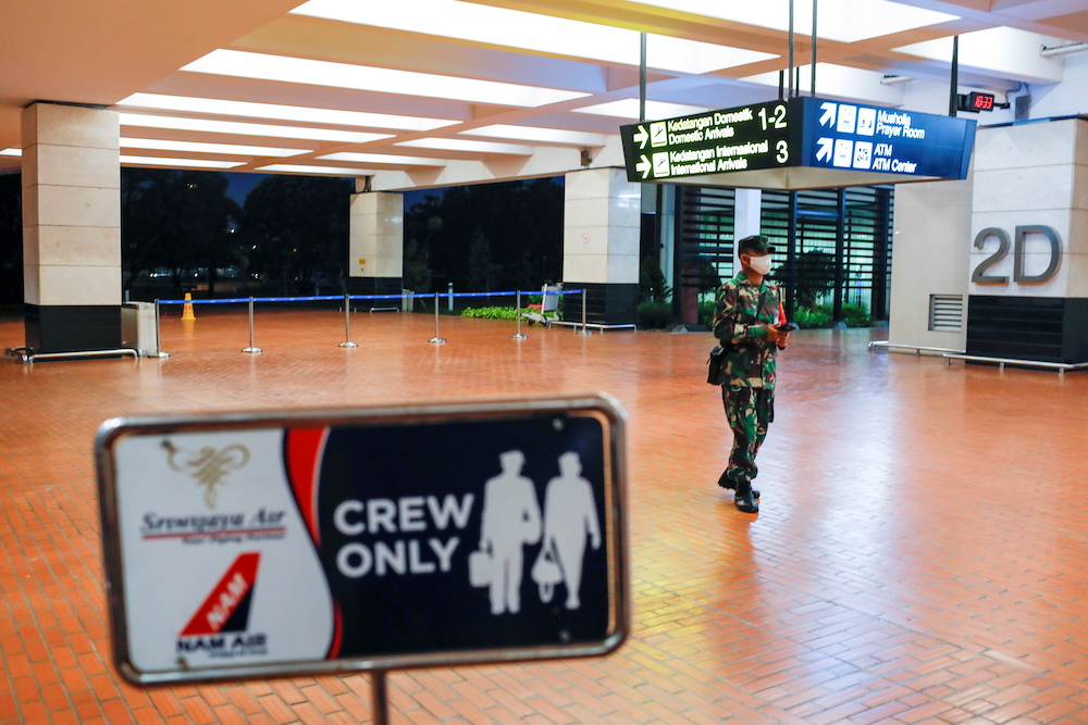 An Indonesian soldier walks at Soekarno-Hatta International Airport after Sriwijaya Air plane flight SJ182 with more than 50 people on board lost contact after taking off, according to local media, in Tangerang, near Jakarta, Indonesia, January 9, 2021. u00e2