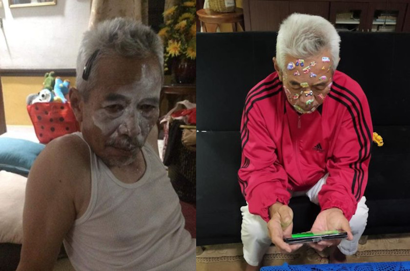 The grandpa doesn’t look particularly bothered by the stickers or makeup on his face. — Picture via Facebook/Anak Sepahkan Apa Hari Ini?
