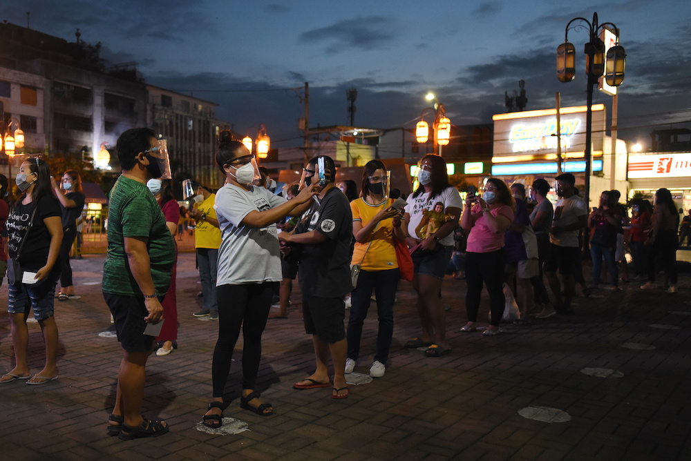 People wearing face masks and face shields as protection against the coronavirus disease queue outside a parish to attend a mass a day before the feast day of Santo Nino or Child Jesus, in Manila, Philippines, January 16, 2021. u00e2u20acu201d Reuters picnnnn