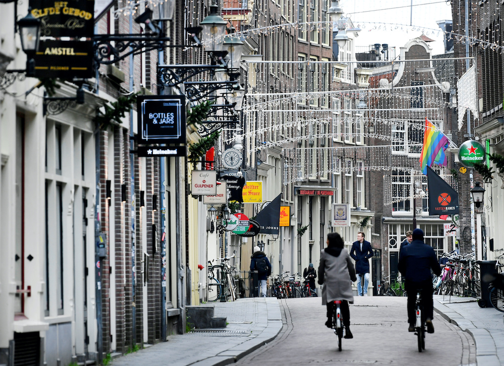 People ride bikes on an empty street as Netherlands has gone into lockdown as the spread of the coronavirus disease continues in Amsterdam, Netherlands December 15 2020. u00e2u20acu2022 Reuters picnnn