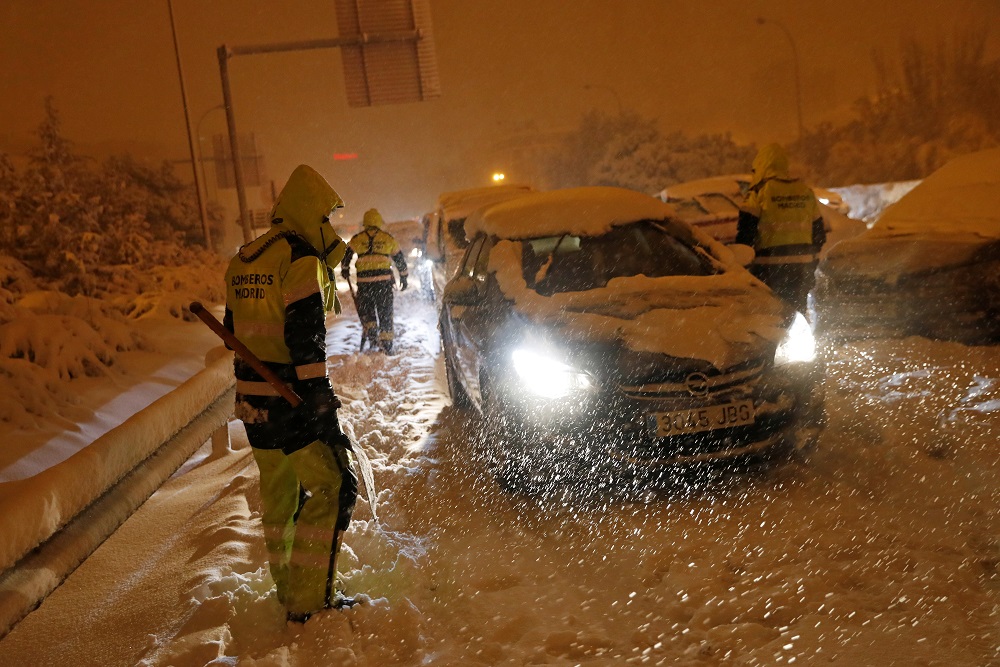 Firefighters tend to stranded drivers on an access road to the M-30 motorway during a heavy snowfall in Madrid, Spain January 8, 2021. u00e2u20acu2022 Reuters pic