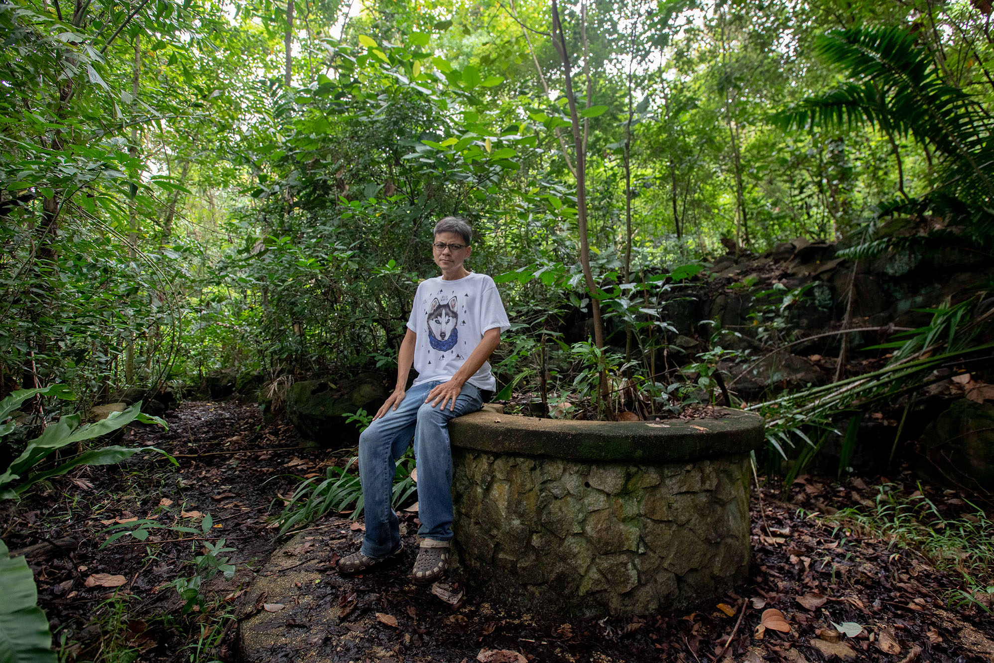 Mr Jimmy Tan posing with an abandoned well at Bukit Batok Hillside Park on Nov 3, 2020. Mr Tan launched an online petition in August last year calling for the preservation of the park. — Photo by Ili Nadhirah Mansor for TODAY