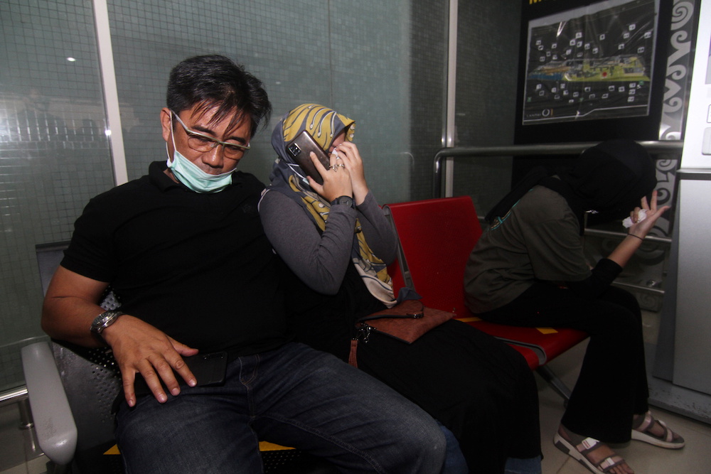 Family of a Sriwijaya Air passenger reacts after Flight SJ182, with more than 50 people on board, lost contact after taking off, according to local media at Supadio Airport, Kubu Raya, West Kalimantan Province, Indonesia, January 9, 2021. u00e2u20acu201d Reuters picn