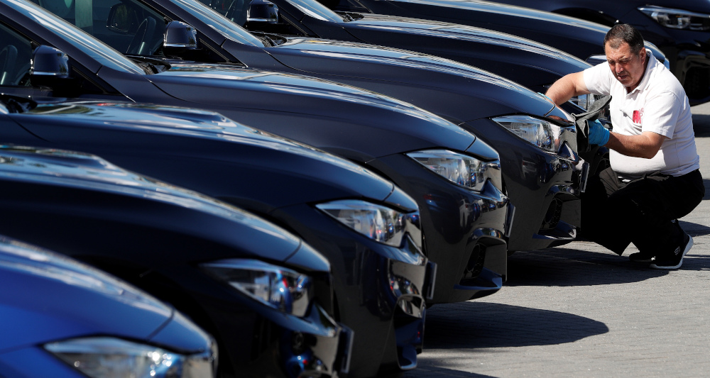 In this file photo taken June 1, 2020 a worker cleans and sanitises a new car, outside a re-opened BMW car dealership, in Hook, south-west of London, following the easing of the lockdown restrictions during the Covid-19 pandemic. u00e2u20acu201d AFP picnn