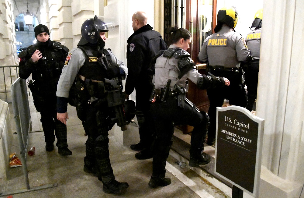 Police from neighbouring Fairfax County, Virginia, arrive at the Senate door after supporters of President Donald Trump breeched security at the US Capitol in Washington January 6, 2021. u00e2u20acu2022 Reuters pic 