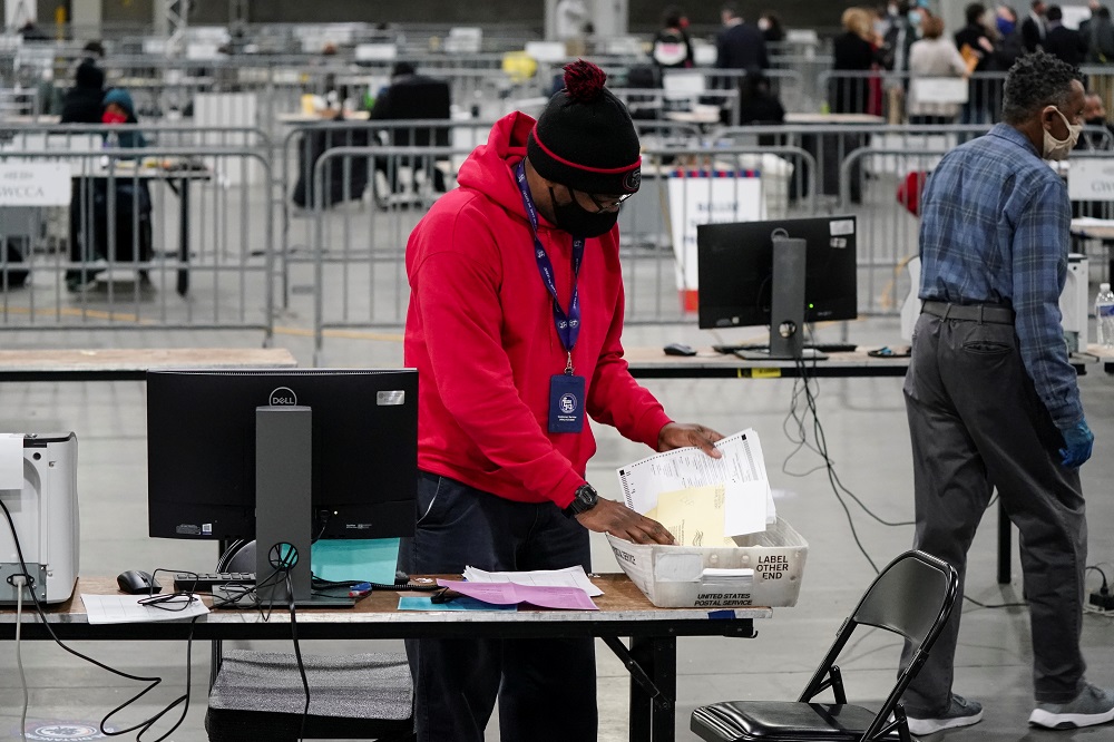 A Fulton County election worker takes absentee ballots out of a container to scan at the Georgia World Congress Center in Atlanta, Georgia January 6, 2021. u00e2u20acu2022 Reuters pic