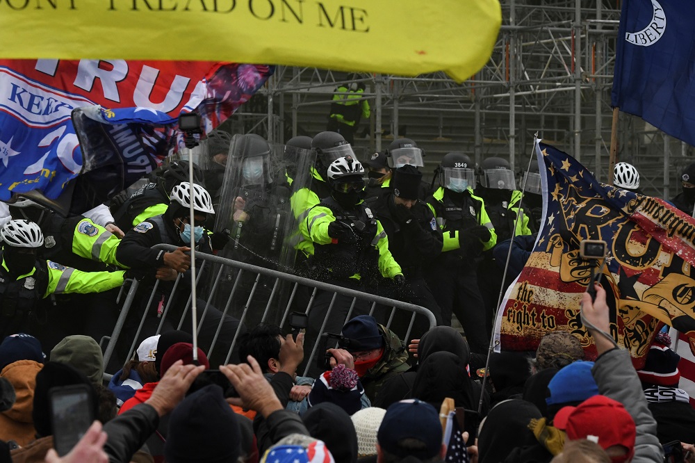 Security forces try to keep supporters of US President Donald Trump outside the US Capitol during a protest against the certification of the 2020 US presidential election results by the US Congress, in Washington January 6, 2021. ― Reuters pic