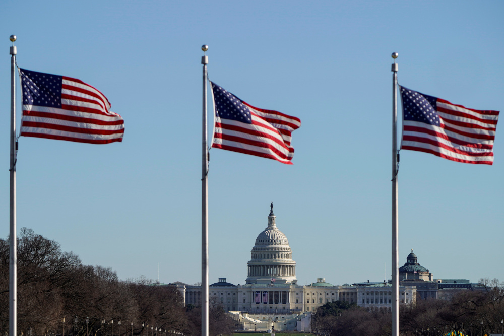 The US Capitol is seen under flags flying on the National Mall days after supporters of US President Donald Trump stormed the US Capitol in Washington, US, January 10, 2021. u00e2u20acu201d Reuters picnn