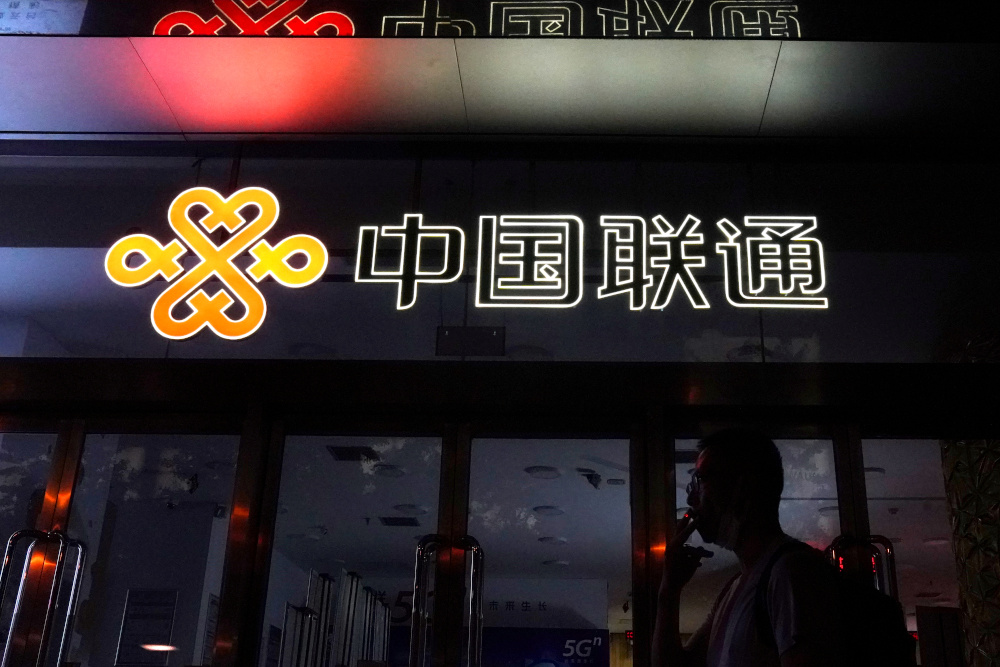 A man smokes in front of a China Unicom store in Beijing, China August 11, 2020. u00e2u20acu201d Reuters pic