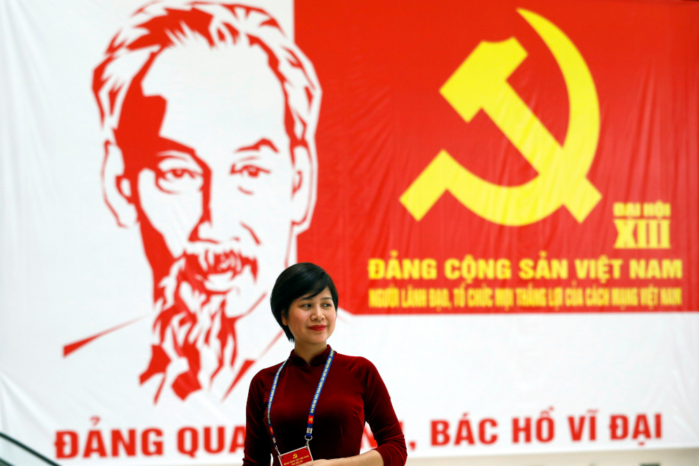 A woman stands near a giant poster at the National Convention Centre, the venue for the upcoming 13th national congress of the ruling Communist Party of Vietnam, in Hanoi, Vietnam January 22, 2021. u00e2u20acu201d Reuters picnn