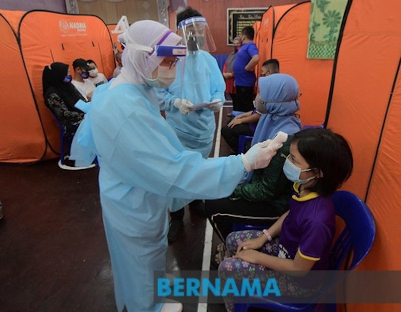A health worker takes the temperature of an evacuee at a flood relief centre. u00e2u20acu201d Picture via Twitter/Bernama