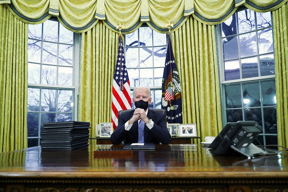 US President Joe Biden signs executive orders in the Oval Office of the White House in Washington, after his inauguration as the 46th President of the United States January 21, 2021. u00e2u20acu2022 Reuters pic