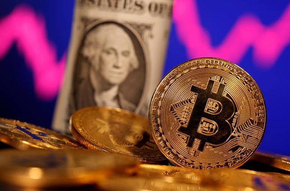 A representation of virtual currency Bitcoin and US One Dollar banknote are seen in front of a stock graph in this illustration taken January 8, 2021. u00e2u20acu201d Reuters pic